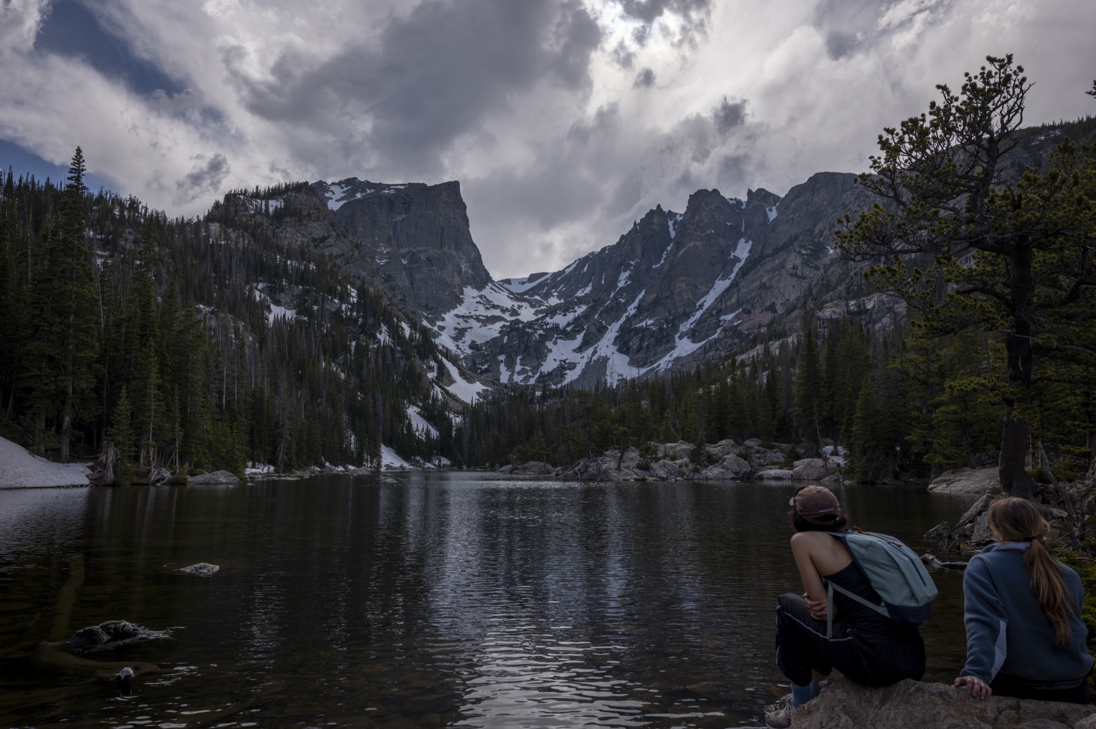 Two people by Dream Lake under Hallett Peak