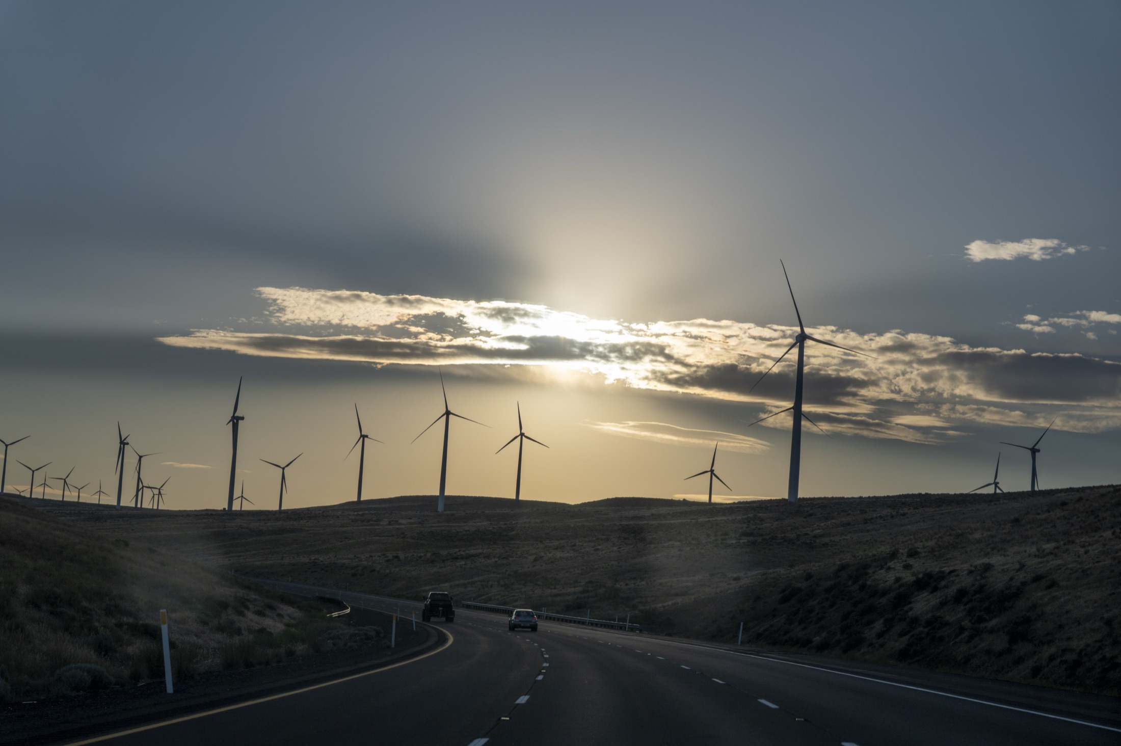 The highway west at sunset, past wind turbines